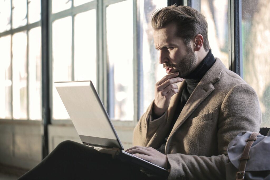 A thoughtful person looking at notes or a laptop, showing the need to find the root cause of a problem_Dennis Yukot